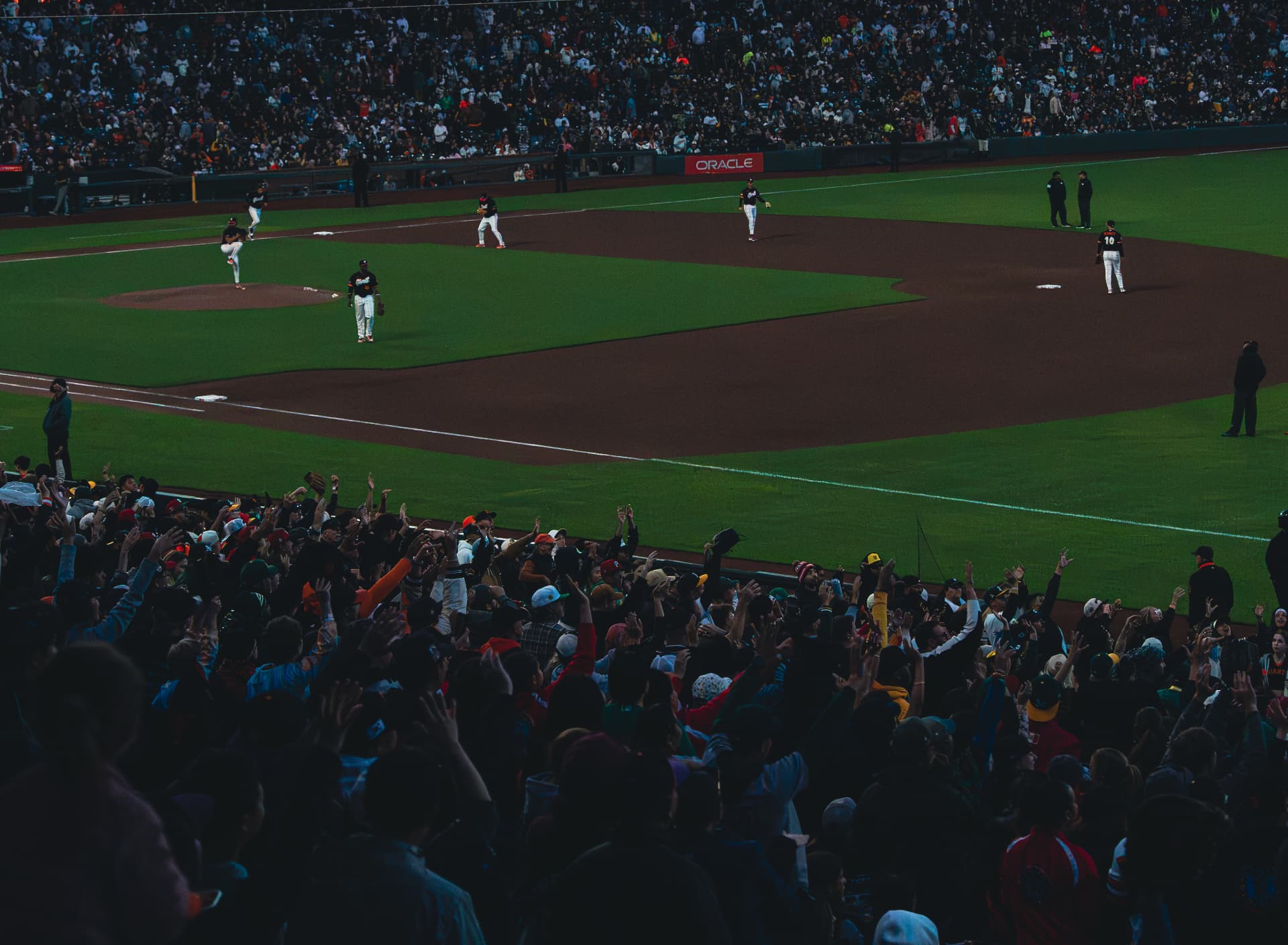 Crowd on their feet as the pitch is delivered at Oracle Park