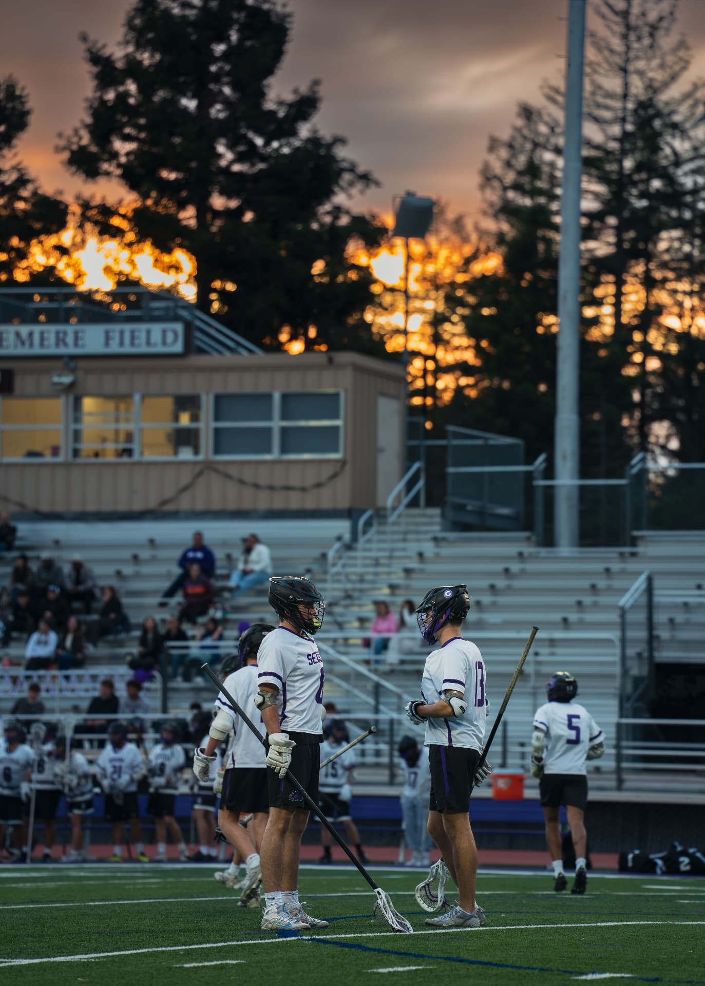 Lacrosse team on the field at sunset