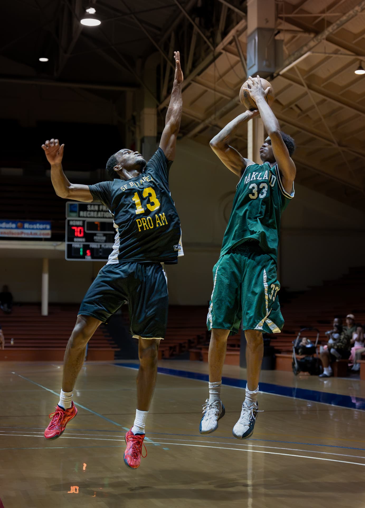 Contested jump shot over an outstretched hand