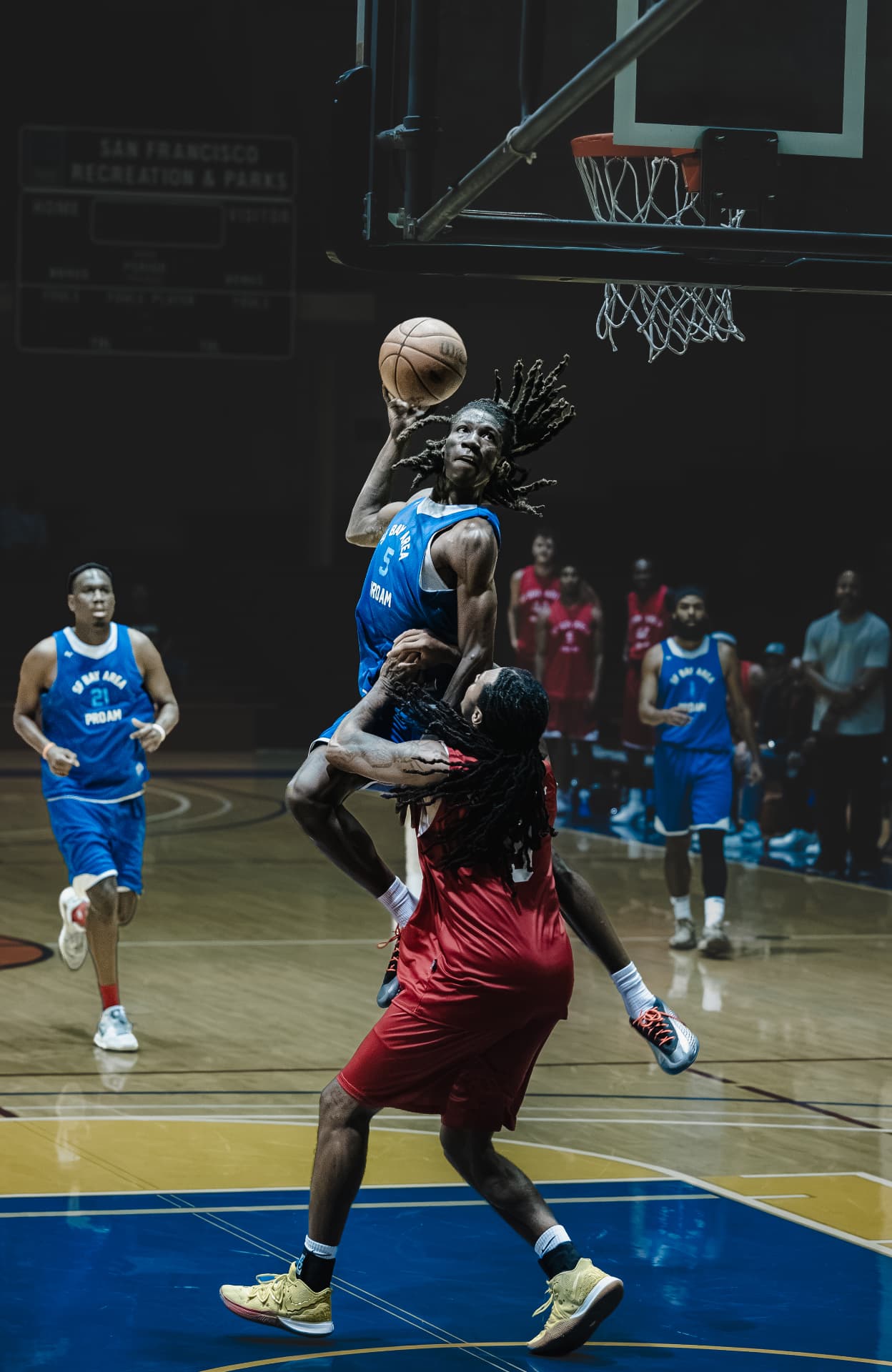 Rising over a defender for a shot at the rim